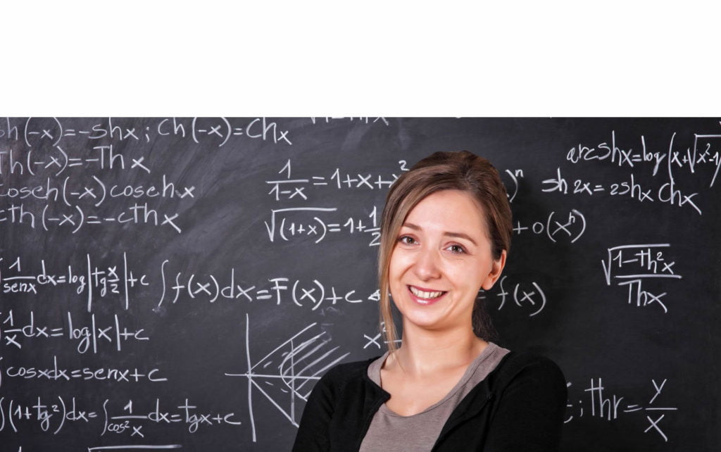 Teacher Standing in Front of Chalk Board