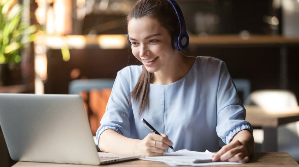 Smiling girl wear wireless headphone study online with skype teacher